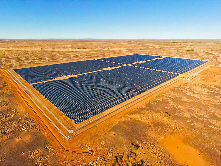 A large solar park stands on a vast, flat area.