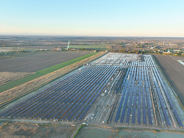 Hugh solar site in Noth Italy with solar panels and a blue sky