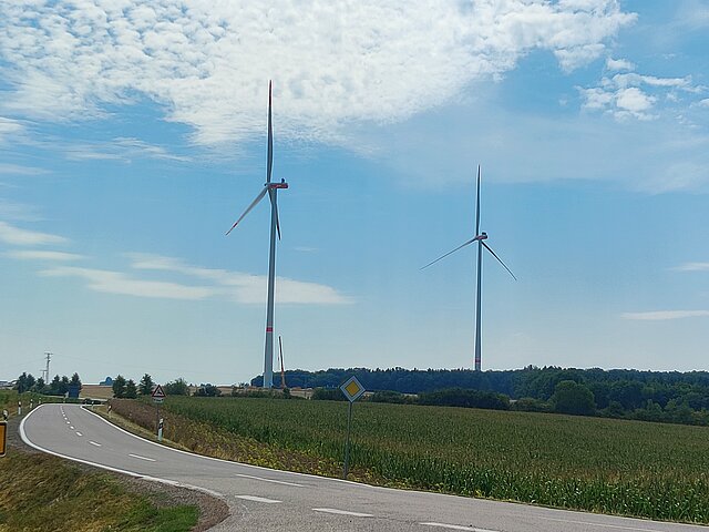 Two wind turbines at the Kröppen wind farm tower into the sky