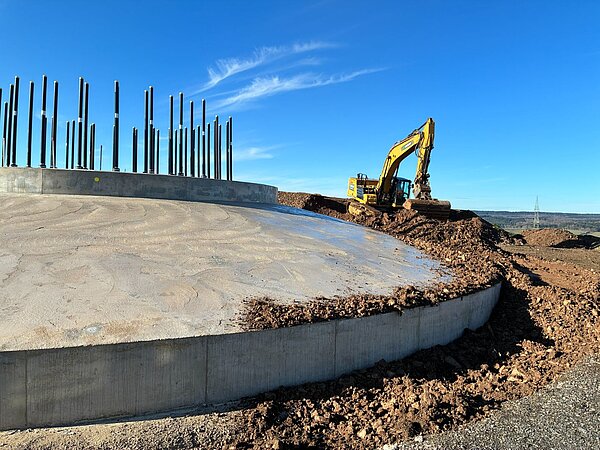 The foundation of a wind farm, including an excavator.