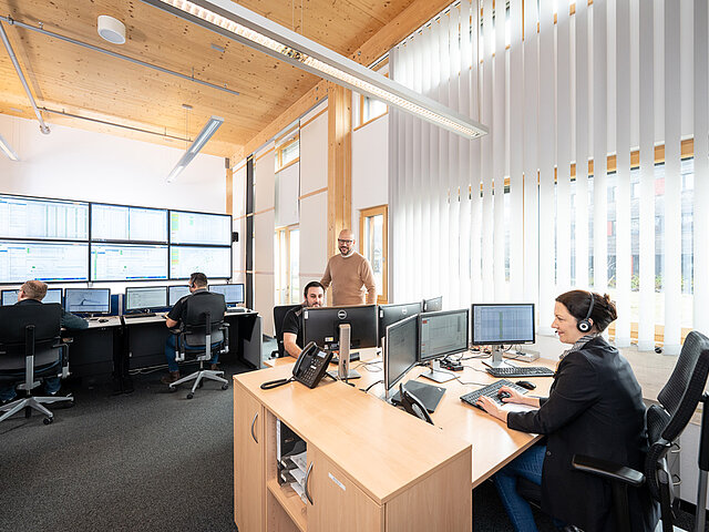 JUWI employees are working in the control room, monitoring the functions of wind and solar power plants.