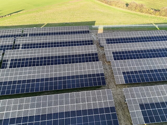 Solar panels in a green field.