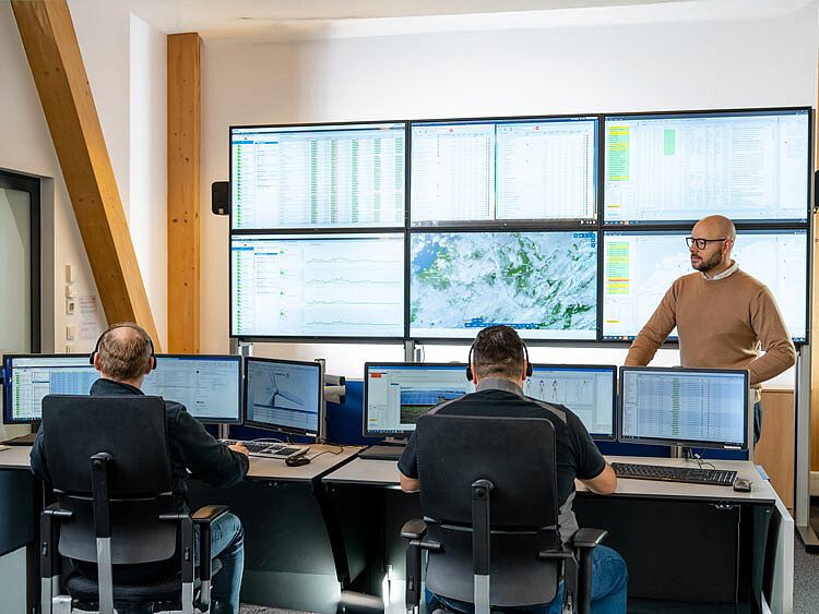 The JUWI control room. Employees sit in front of several large screens, monitoring the data from various JUWI facilities.
